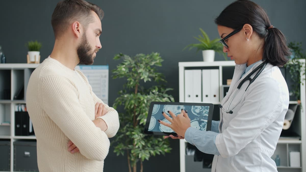 Doctor showing simulation results to patient on tablet